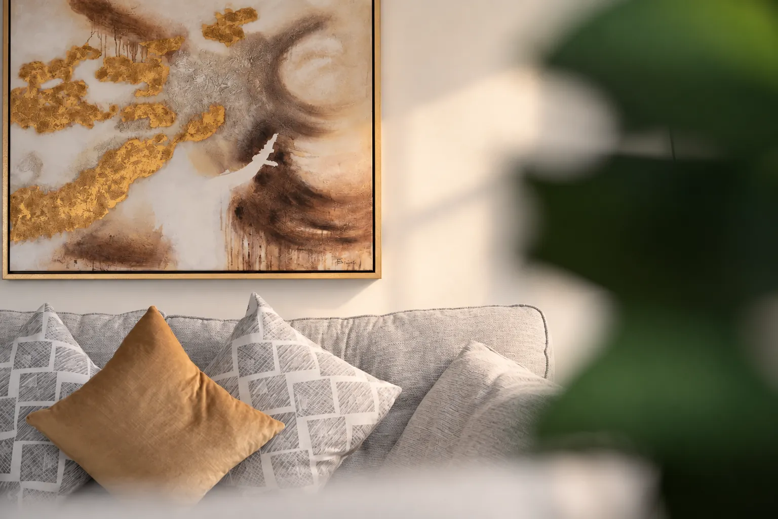 Mustard cushion and gold abstract artwork, Belfast apartment detail